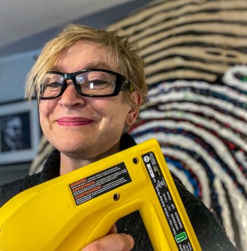 Lorna holding a staple gun