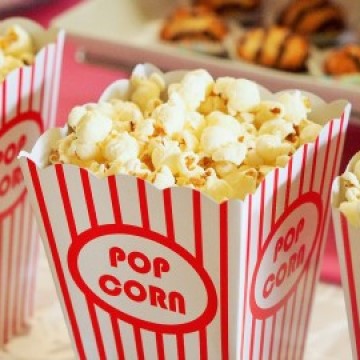 The image is a box of popcorn with the word "POP" on top and "CORO" and "CORN" below. The box likely contains kettle corn or sweet popcorn, and it is a snack or junk food item.