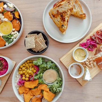 The image shows a table filled with food at the modern pantry restaurant. Tags associated with the image include meal, food, dish, table, cuisine, plate, brunch, platter, fast food, tableware, snack, lunch, baked goods, ingredient, dishware, staple food, vegetable, supper, full breakfast, recipe, indoor, salad, and breakfast.