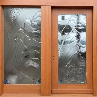 The windows are part of Anthony Jamieson Design Studio and feature glass works on a wooden frame.