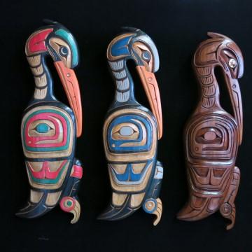 The photo depicts a group of colorfully painted statues created by Artie George, an indigenous artist.
