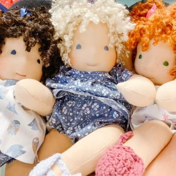 The image shows a group of Bamboletta Dolls, Ltd toys, which are handmade dolls. They are stuffed toys resembling people or babies.