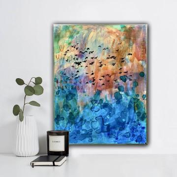 The image shows a vase with flowers placed next to a painting on a wall. The painting appears to be a modern art piece. It is a snapshot of indoor decor with elements of art and nature. The artist associated with the painting is Dana Huhn.