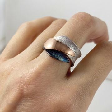 The ring is a fashion accessory. It is made of silver, bronze and a blue metal.