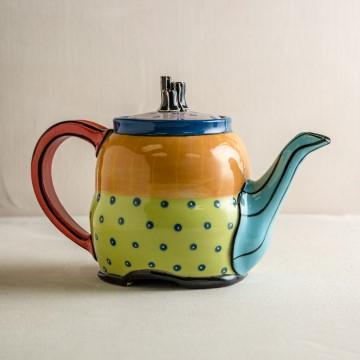 The image features a ceramic teapot with a lid. It is a piece of Laura van der Linde's ceramic art, showcasing still life photography. The teapot is a part of kitchenware and serveware, suitable for indoor use.