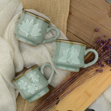The image shows three mugs from Grass Mountain Pottery. The tags associated with the image are ceramic, mug, indoor, tableware, porcelain, coffee cup, silverware, table, wooden, and coffee.