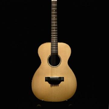 The image is of a guitar against a black background. It features a musical instrument, specifically a guitar, which can be either acoustic or electric. The photo does not reveal any specific details about the guitar itself, like its brand or model.