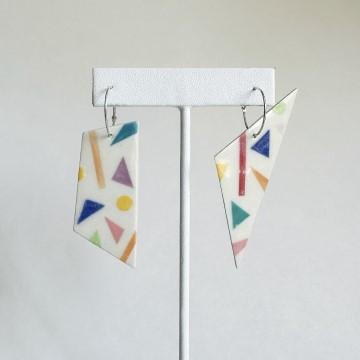 The image features a couple of earrings on a pole. The earrings are associated with Studio Eighteen earrings and jewelry. Tags include flag, origami, and art.
