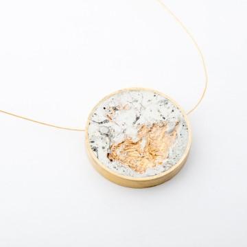 The image shows necklace with a stone on it. It is related to fashion accessory and jewelry, possibly showcasing items from the brand dconstruct jewelry.