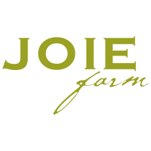 The image is a logo for Joie Farm Winery. The logo consists of the text "JOIE" with the word "Carm" underneath. It is a graphic design that focuses on typography and font.